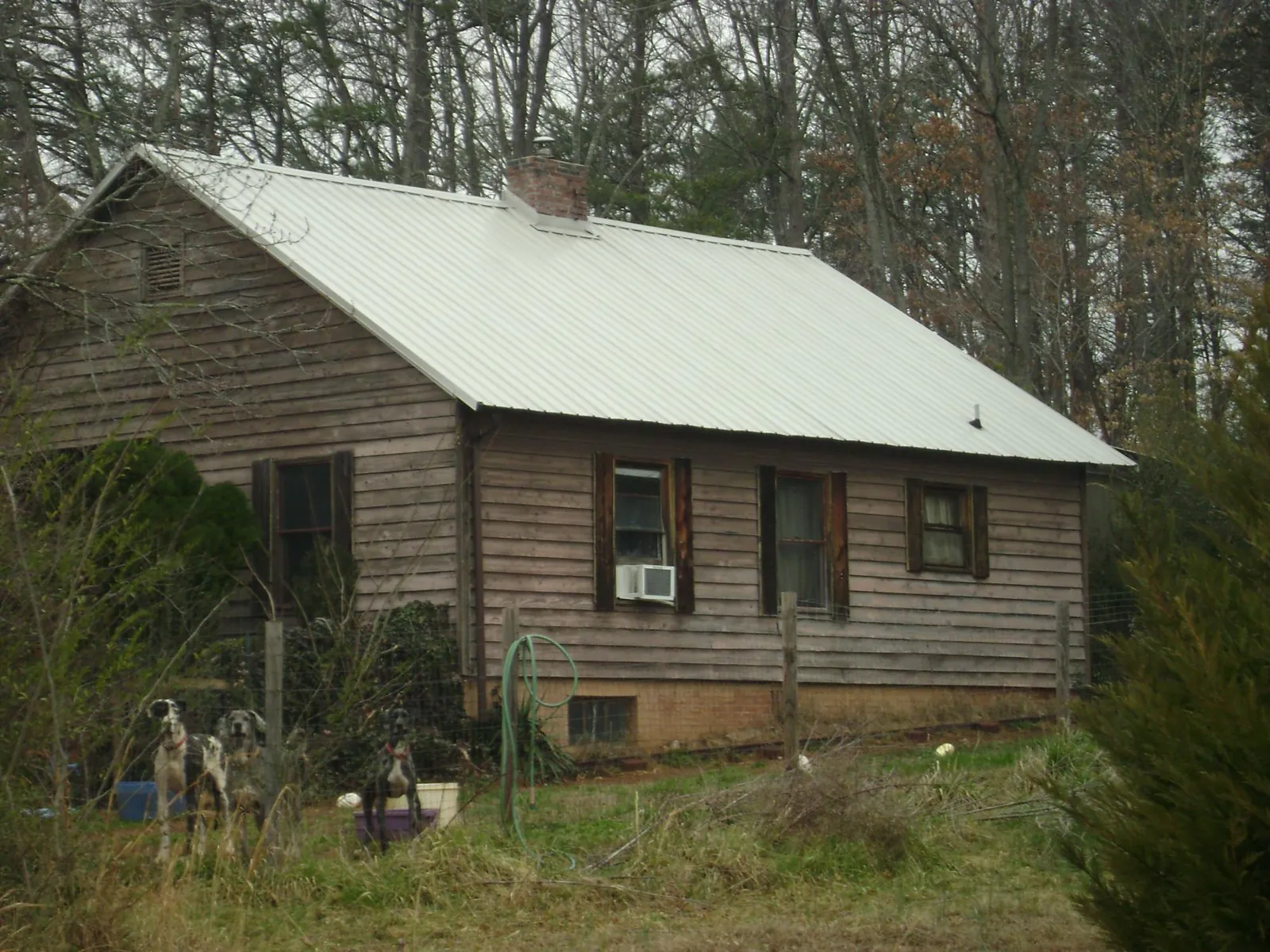 White metal roof on an old wood sided farmhouse, from a Asphalt Shingle Roof Repair job in Lawndale